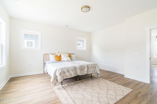 a spacious bathroom with a granite countertop double vanity sink and a mirror