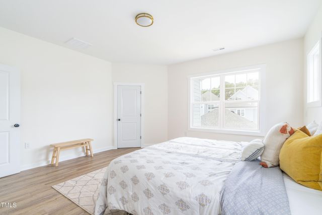 a view of a livingroom with wooden floor and a hallway