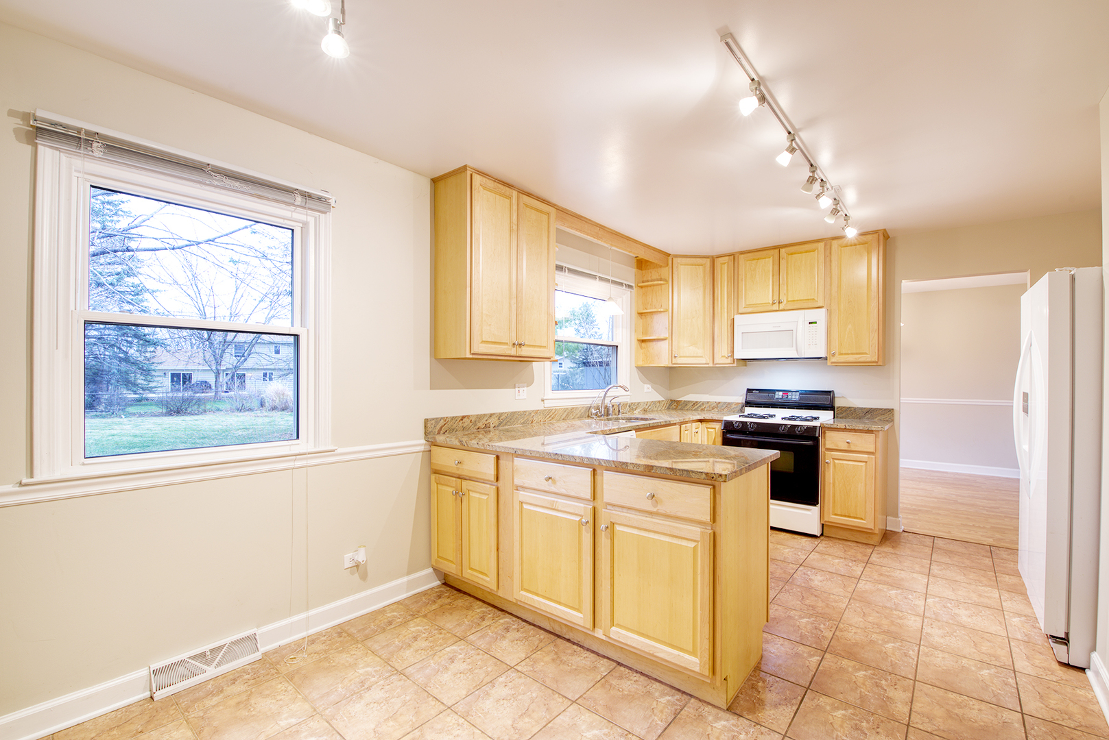 403 Northgate Road Lindenhurst, IL 60046 - Photo 14 of 22 a kitchen with stainless steel appliances granite countertop a stove refrigerator and a window