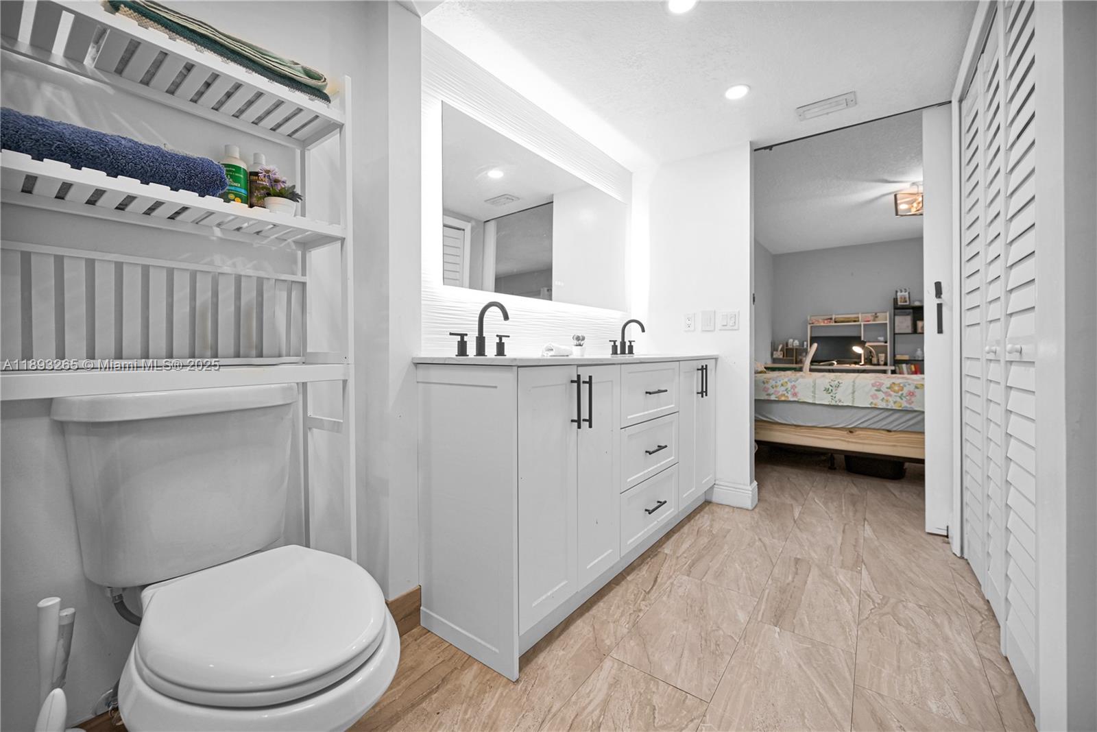 10101 Southwest 154th Cir Court, Unit 10711 Miami, FL 33196 - Photo 16 of 63 a bathroom with a toilet a sink a mirror a bathtub and shower