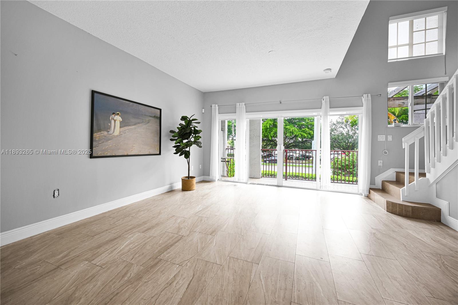 10101 Southwest 154th Cir Court, Unit 10711 Miami, FL 33196 - Photo 26 of 63 a view of an empty room with wooden floor and a window