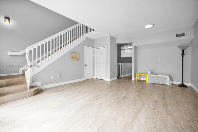 a kitchen with a sink stainless steel appliances and white cabinets