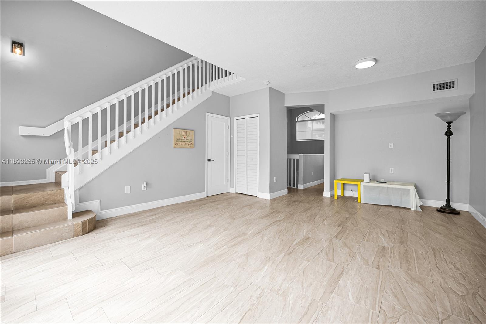 10101 Southwest 154th Cir Court, Unit 10711 Miami, FL 33196 - Photo 29 of 63 a view of a livingroom with wooden floor and white walls