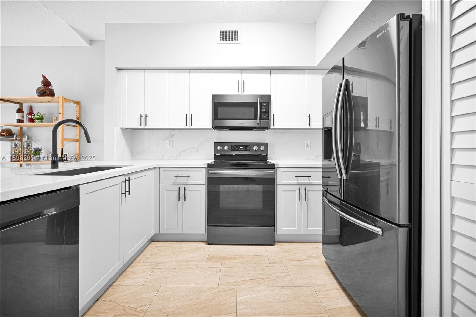 10101 Southwest 154th Cir Court, Unit 10711 Miami, FL 33196 - Photo 34 of 63 a kitchen with a refrigerator stove and sink