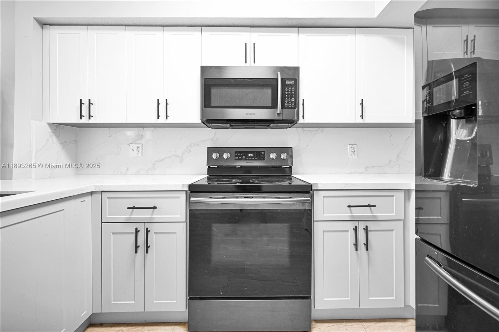 10101 Southwest 154th Cir Court, Unit 10711 Miami, FL 33196 - Photo 36 of 63 a kitchen with stainless steel appliances granite countertop a stove and a microwave