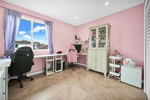 a bedroom with a bed and teddy bear on bed