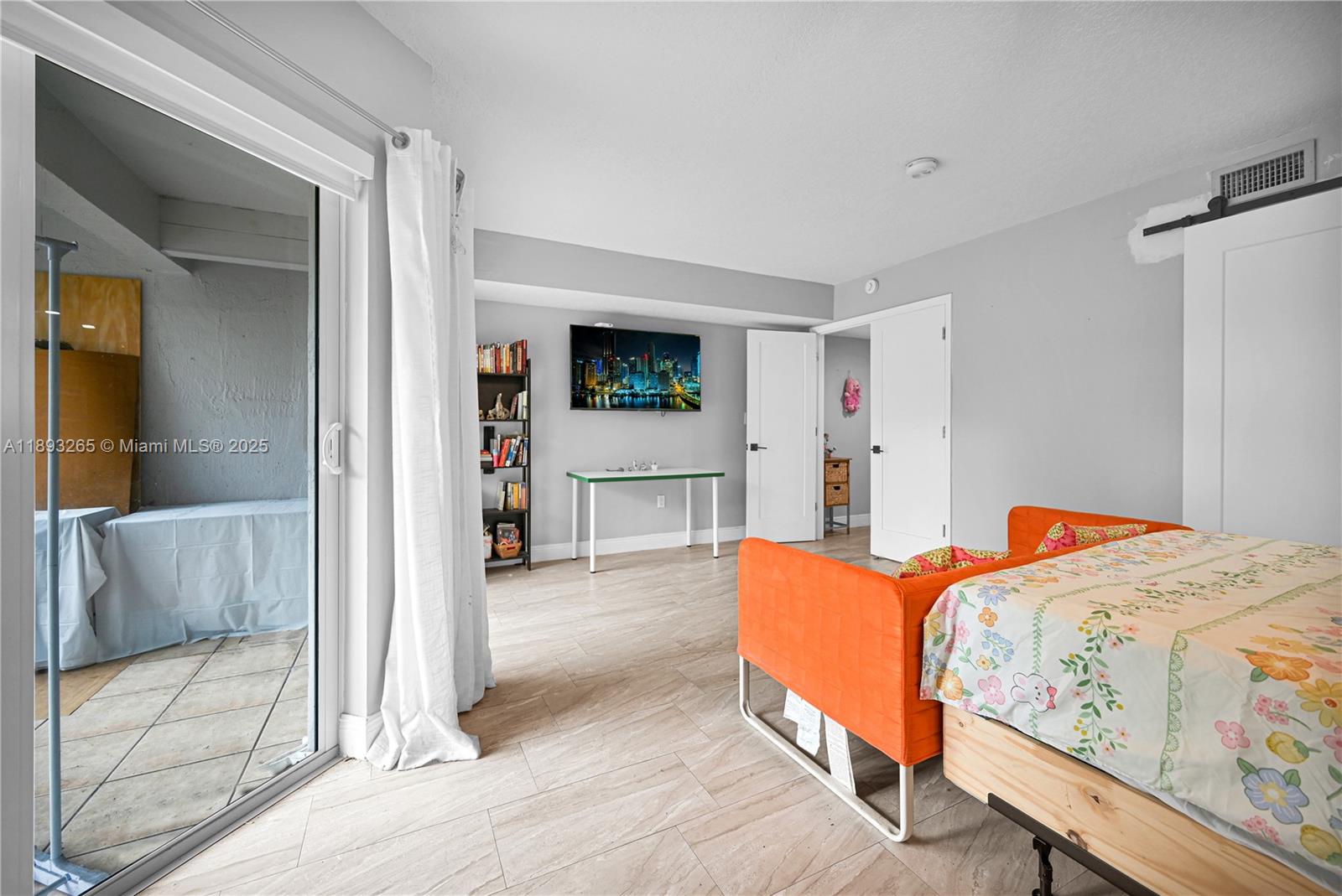 10101 Southwest 154th Cir Court, Unit 10711 Miami, FL 33196 - Photo 9 of 63 a bedroom with a bed and a couch