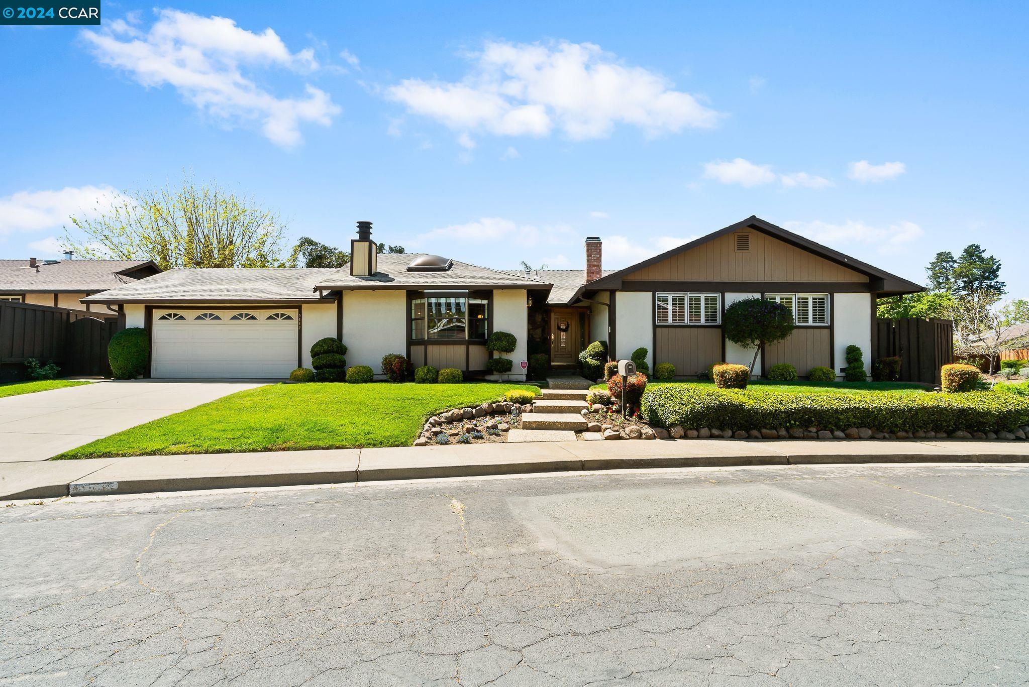 a front view of house with yard and green space