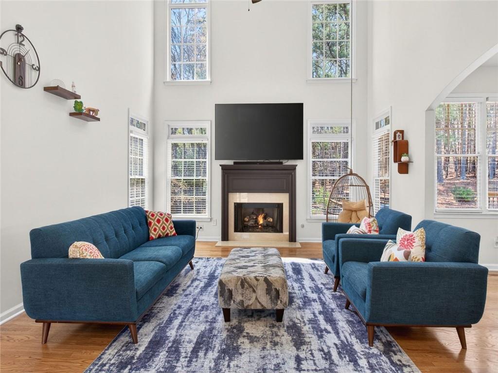 8840 Appling Ridge Cumming, GA 30041 - Photo 17 of 87 a living room with furniture a flat screen tv and a fireplace