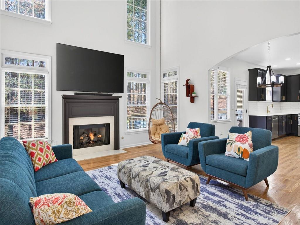 8840 Appling Ridge Cumming, GA 30041 - Photo 18 of 87 a living room with furniture a flat screen tv and a fireplace