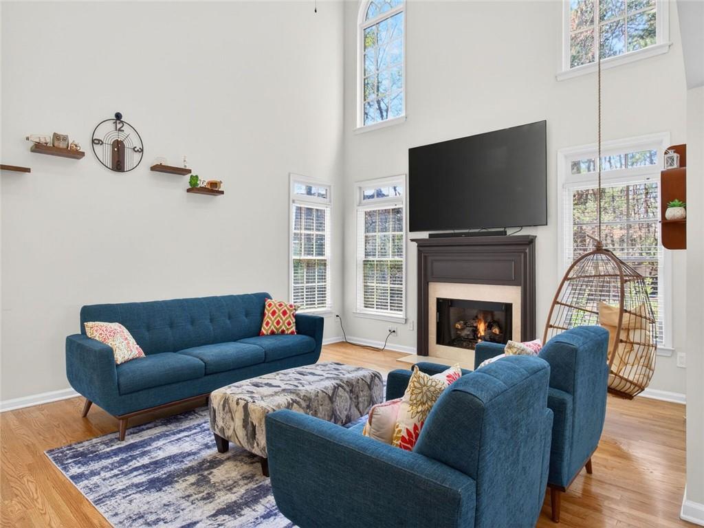 8840 Appling Ridge Cumming, GA 30041 - Photo 19 of 87 a living room with furniture a flat screen tv and a fireplace
