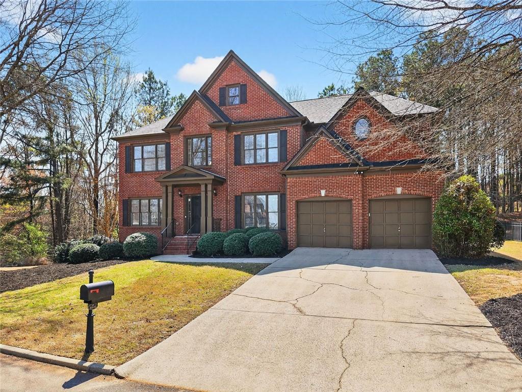 8840 Appling Ridge Cumming, GA 30041 - Photo 2 of 87 a front view of a house with garden