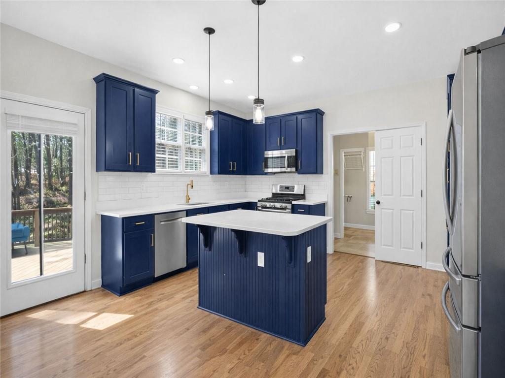8840 Appling Ridge Cumming, GA 30041 - Photo 26 of 87 a kitchen with stainless steel appliances granite countertop a stove a sink dishwasher a refrigerator and a wooden cabinets