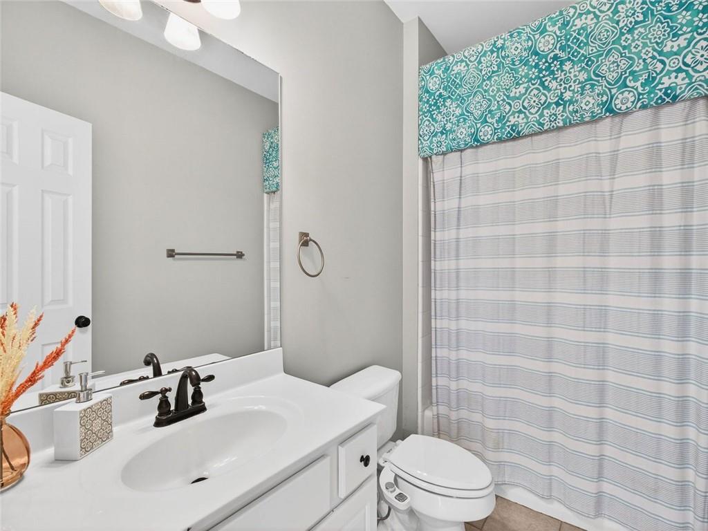 8840 Appling Ridge Cumming, GA 30041 - Photo 30 of 87 a bathroom with a sink a toilet and shower