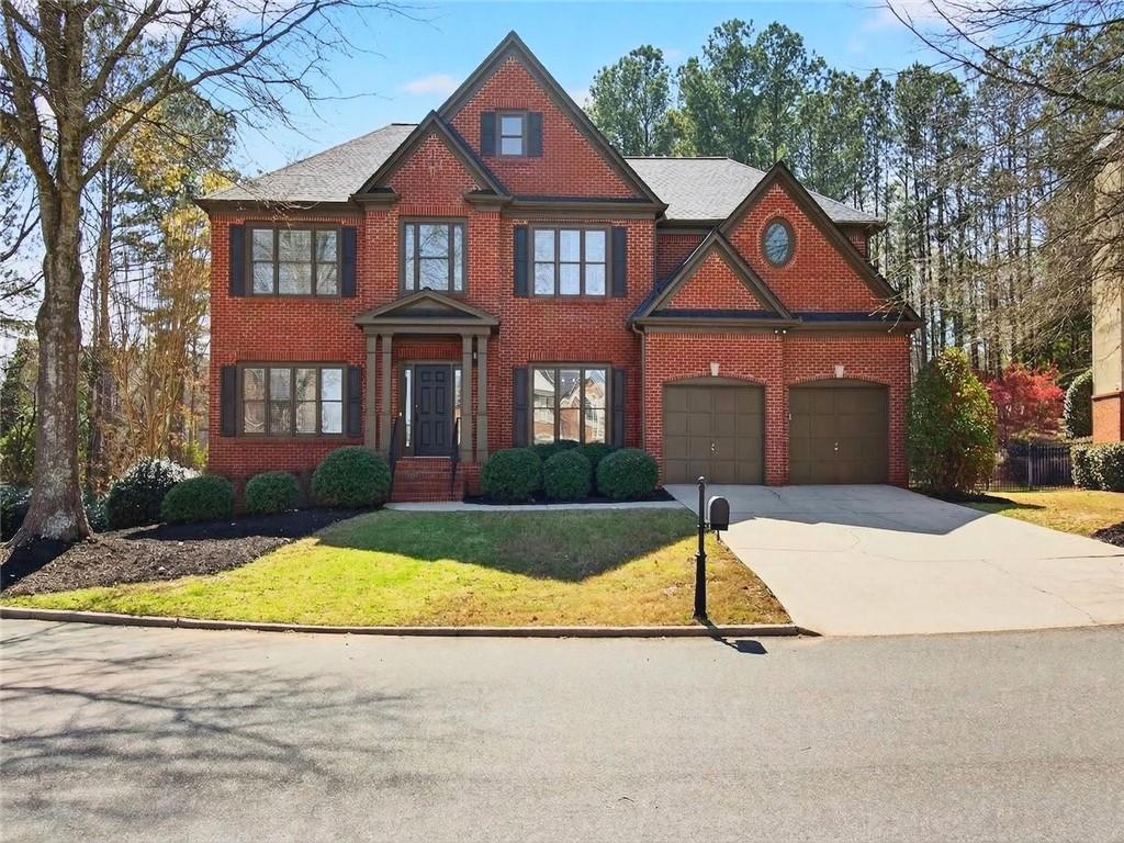 8840 Appling Ridge Cumming, GA 30041 - Photo 3 of 87 a front view of a house with yard and garage