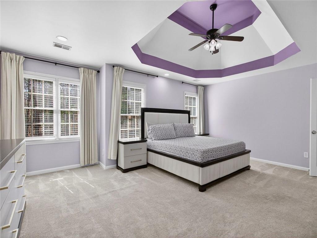 8840 Appling Ridge Cumming, GA 30041 - Photo 34 of 87 a spacious bedroom with a bed and window