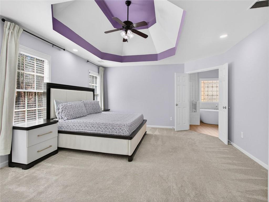 8840 Appling Ridge Cumming, GA 30041 - Photo 35 of 87 a bedroom with a bed chandelier and a window