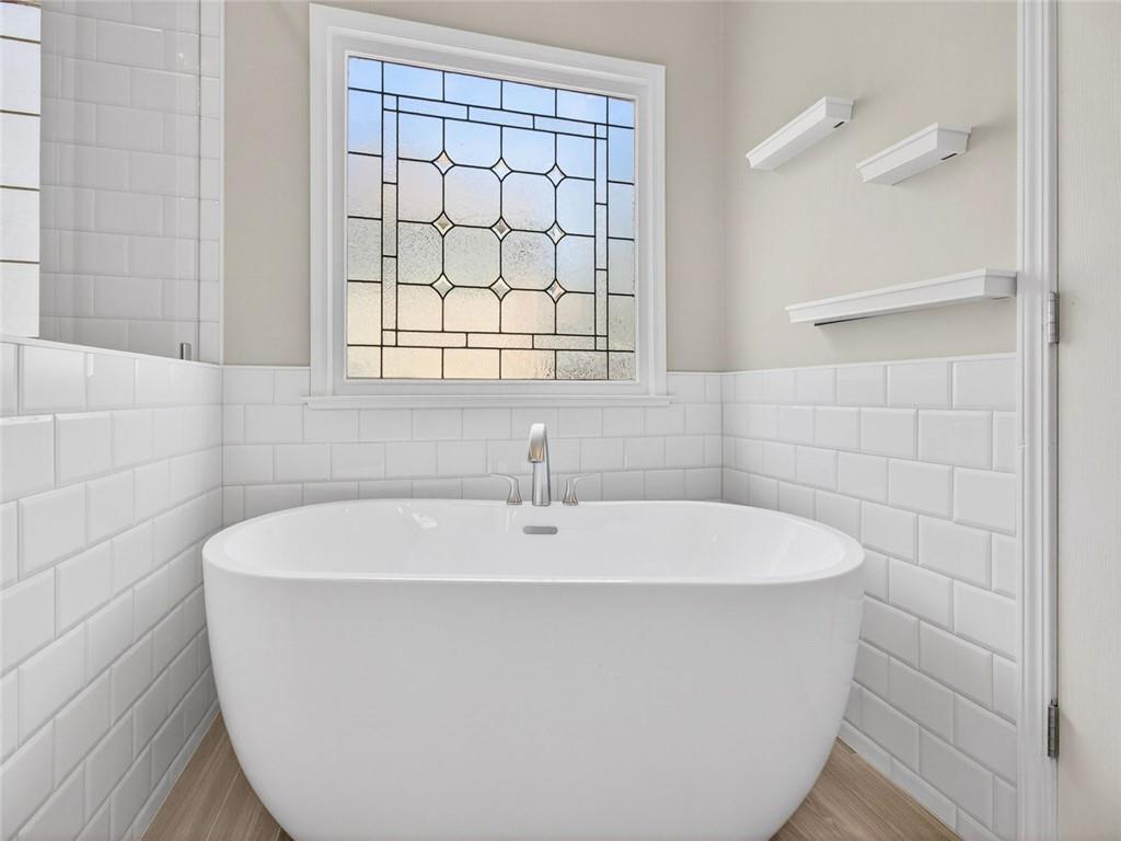 8840 Appling Ridge Cumming, GA 30041 - Photo 40 of 87 a white bath tub sitting in a bathroom next to a window