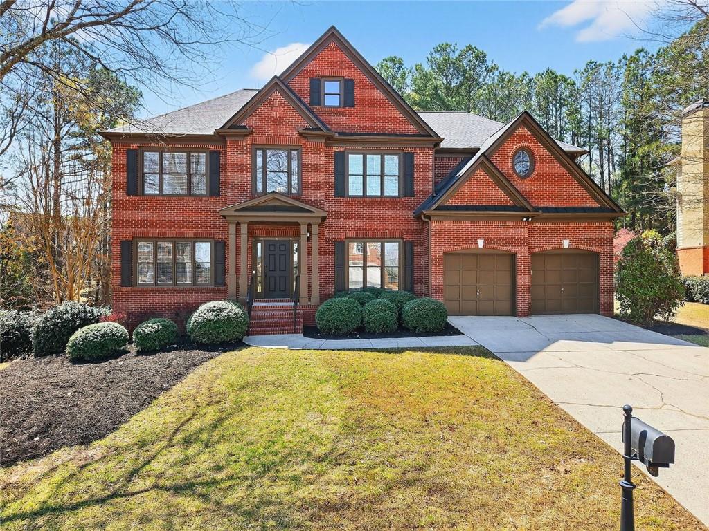 8840 Appling Ridge Cumming, GA 30041 - Photo 4 of 87 a front view of a house with garden