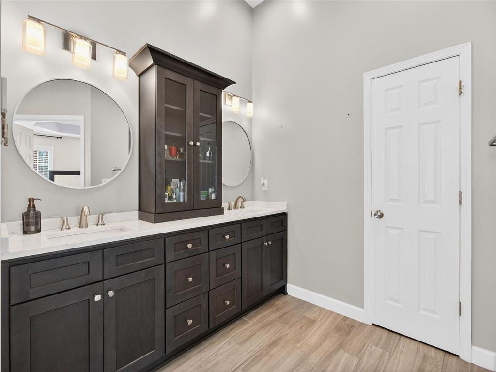 8840 Appling Ridge Cumming, GA 30041 - Photo 41 of 87 a en suite bathroom with a double vanity sink and a mirror