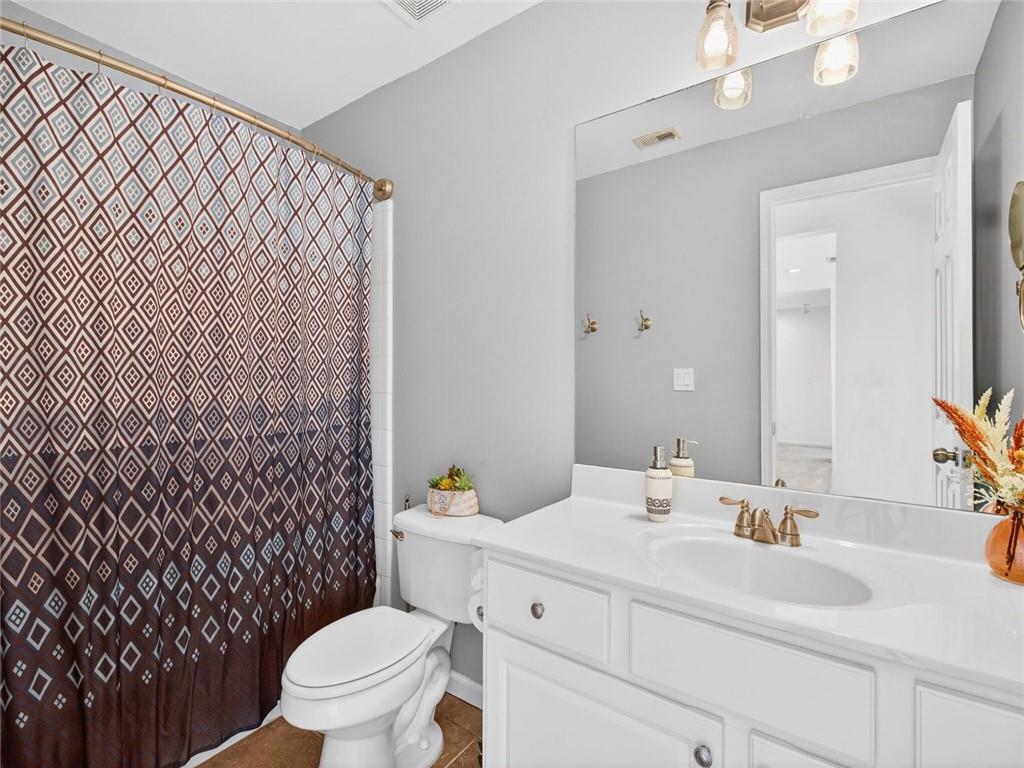 8840 Appling Ridge Cumming, GA 30041 - Photo 50 of 87 a bathroom with a sink toilet vanity and shower