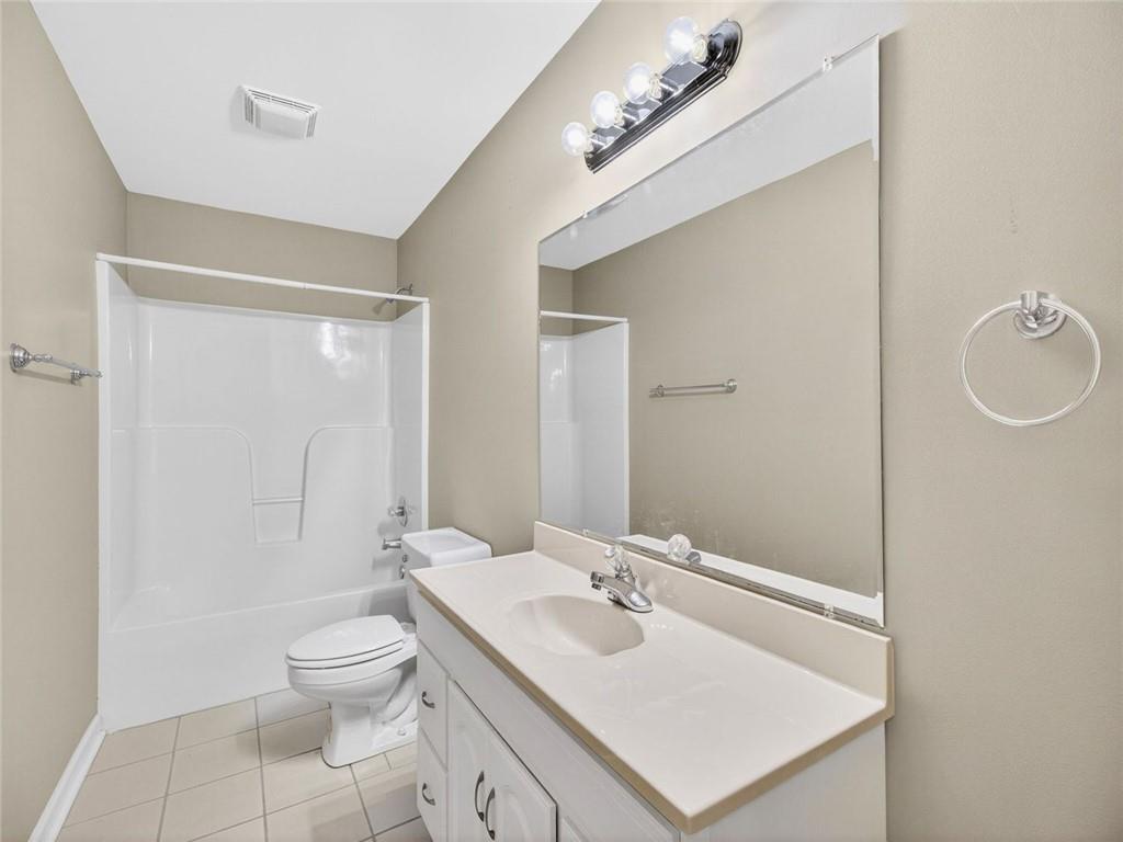 8840 Appling Ridge Cumming, GA 30041 - Photo 56 of 87 a bathroom with a sink a toilet a mirror and shower