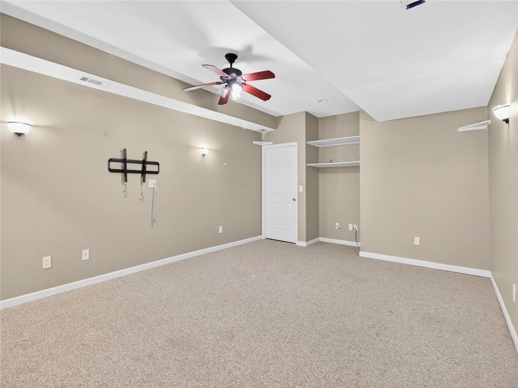 8840 Appling Ridge Cumming, GA 30041 - Photo 62 of 87 a view of an empty room with a ceiling fan