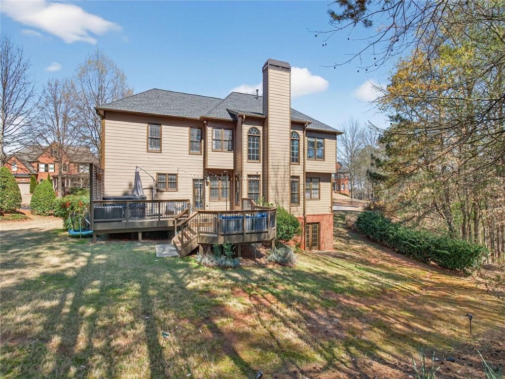 8840 Appling Ridge Cumming, GA 30041 - Photo 72 of 87 a view of a house with backyard and sitting area