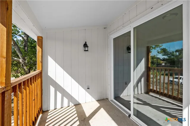 a view of balcony with wooden floor