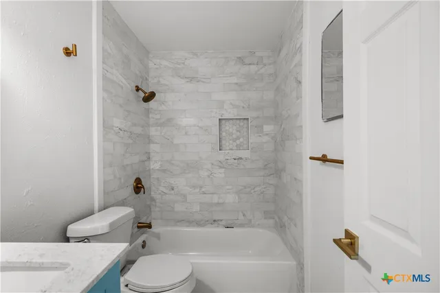 a bathroom with a sink toilet and bathtub