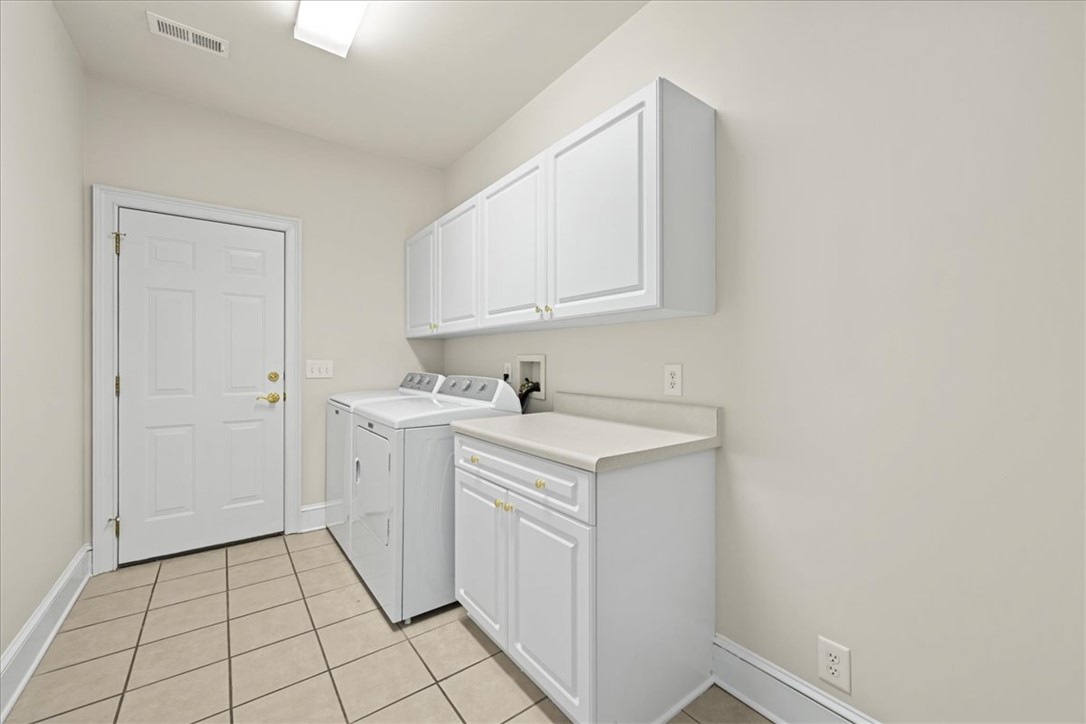 38 Angus Run Seneca, SC 29672 - Photo 26 of 46 This functional laundry room features convenient storage and durable flooring.