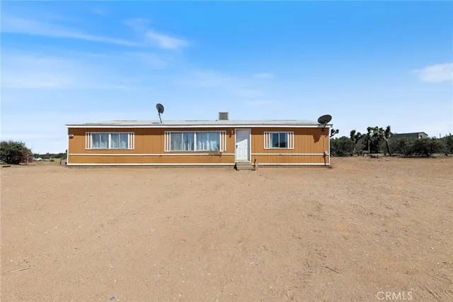 a view of house with yard