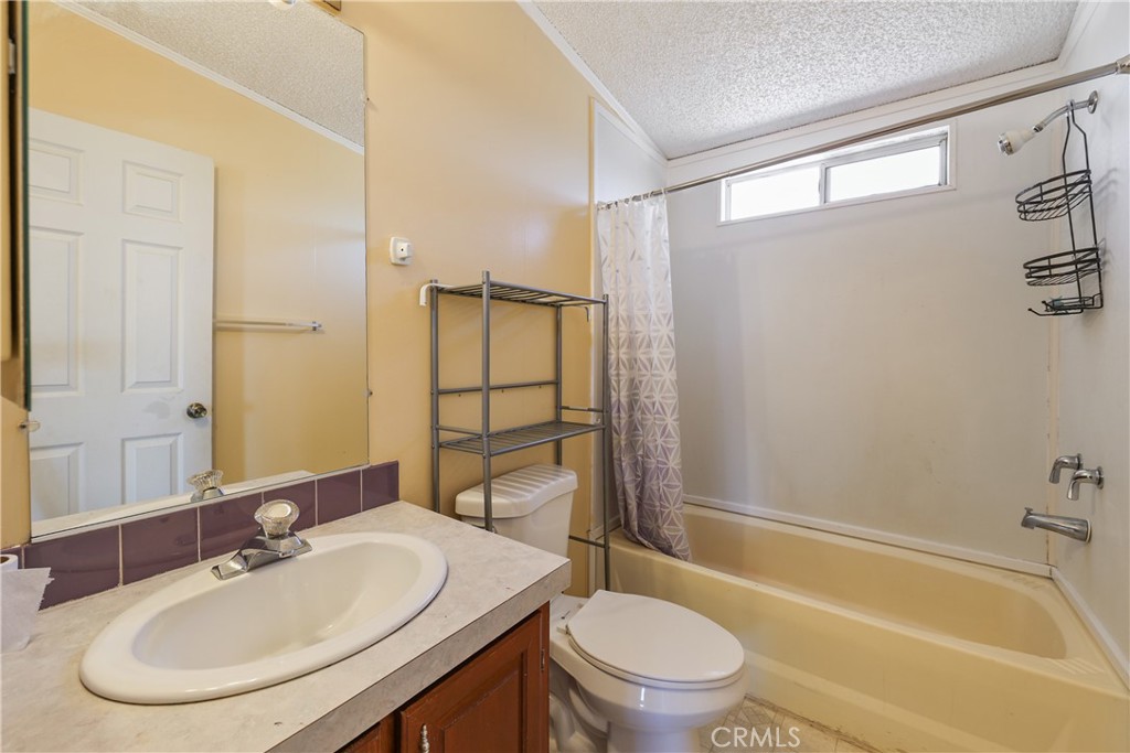 8195 Alta Mesa Road Oak Hills, CA 92344 - Photo 12 of 33 a bathroom with a sink toilet and shower