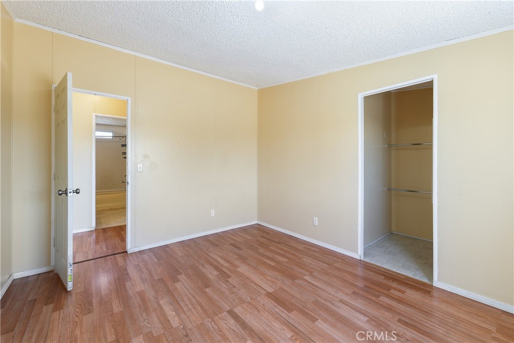 8195 Alta Mesa Road Oak Hills, CA 92344 - Photo 13 of 33 a view of an empty room with wooden floor and closet