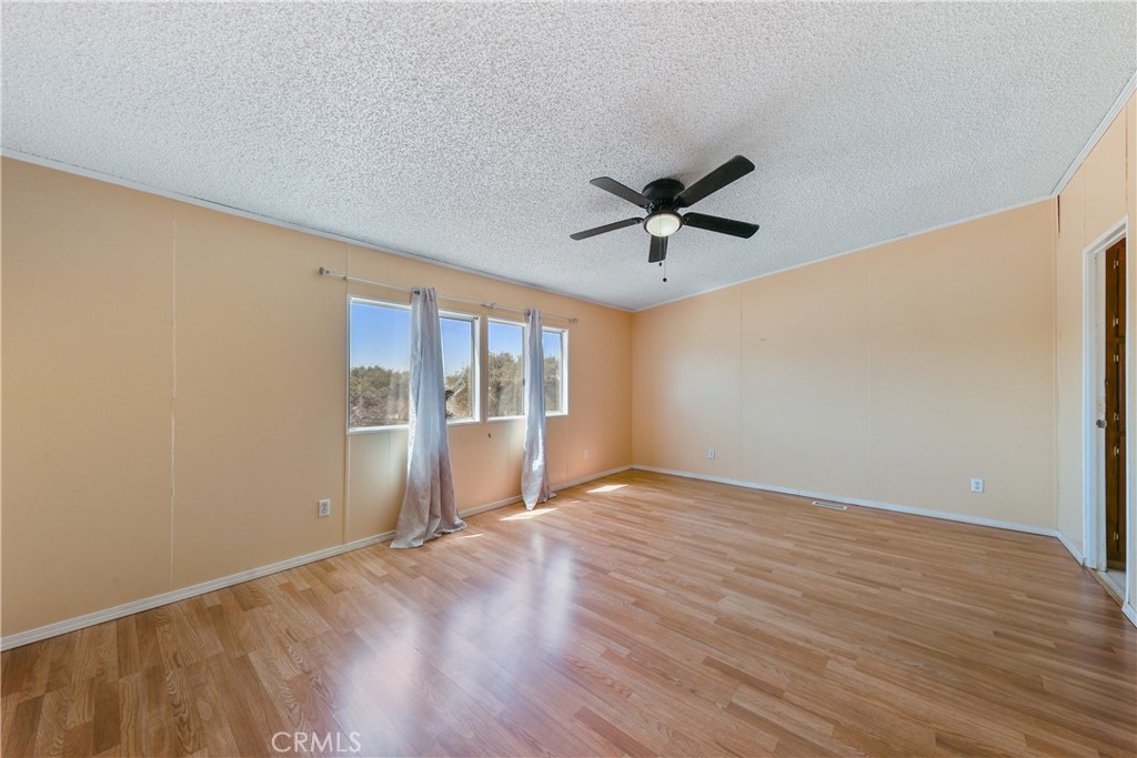 8195 Alta Mesa Road Oak Hills, CA 92344 - Photo 18 of 33 wooden floor in an empty room with a window