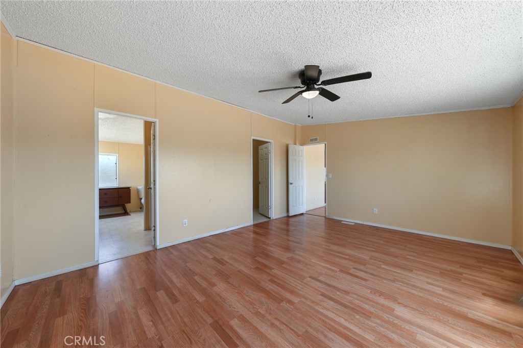 8195 Alta Mesa Road Oak Hills, CA 92344 - Photo 19 of 33 a view of empty room with wooden floor