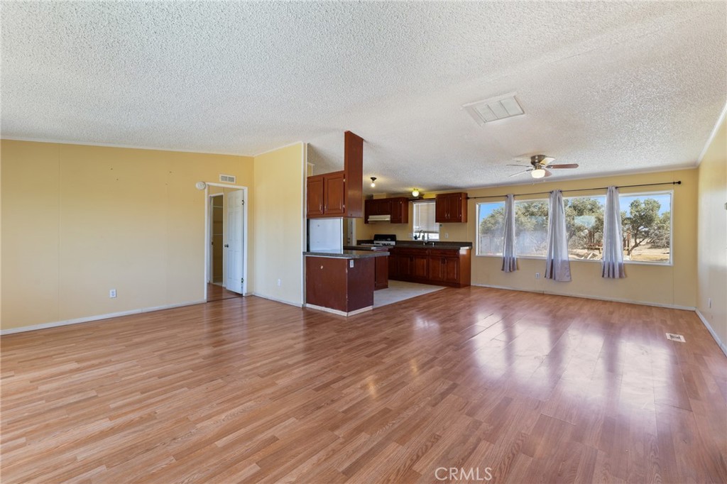 8195 Alta Mesa Road Oak Hills, CA 92344 - Photo 3 of 33 a view of a kitchen with furniture wooden floor and windows