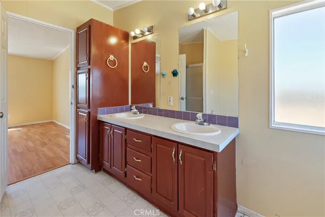 a bathroom with a double vanity sink and a mirror