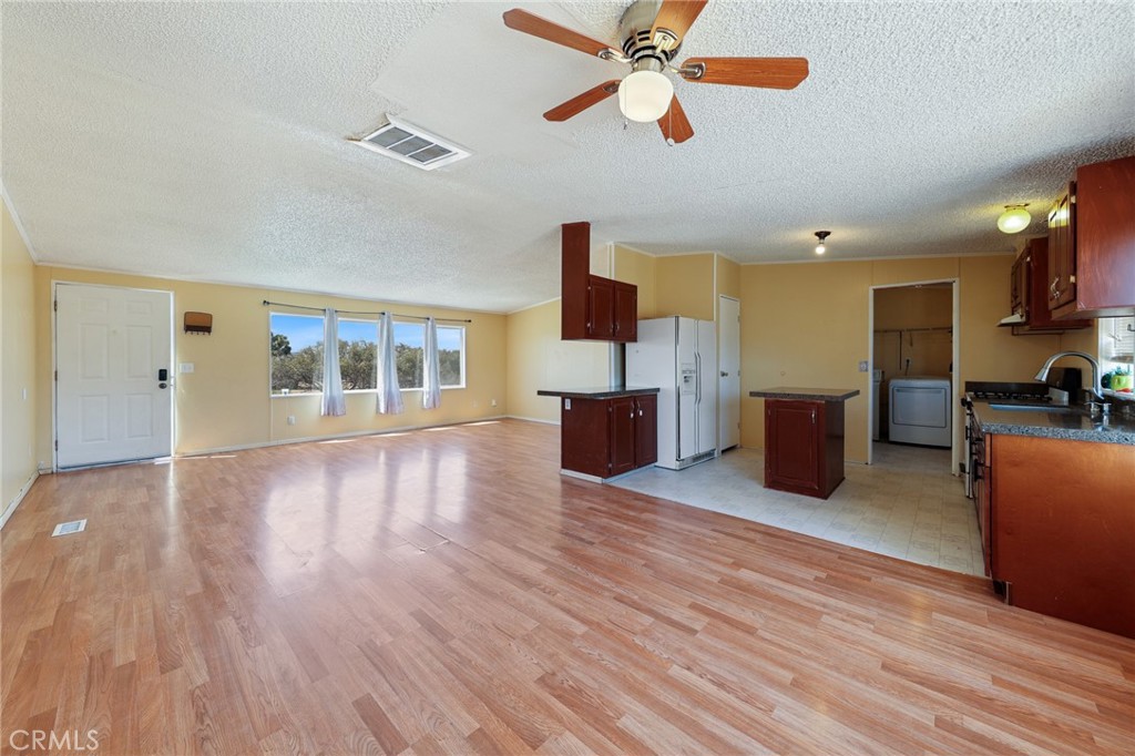 8195 Alta Mesa Road Oak Hills, CA 92344 - Photo 7 of 33 a view of kitchen with furniture and wooden floor