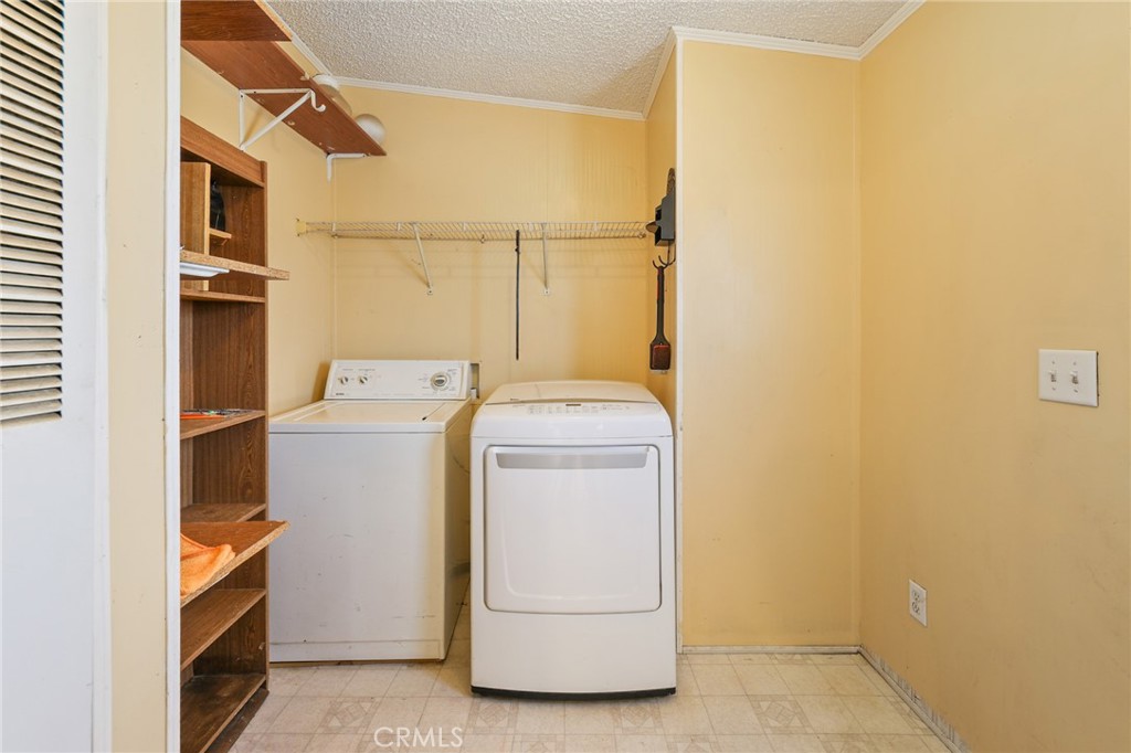 8195 Alta Mesa Road Oak Hills, CA 92344 - Photo 10 of 33 a utility room with dryer and washer