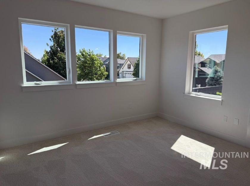755 West Wrangler Street Meridian, ID 83646 - Photo 21 of 35 Neutral-toned carpeting and white walls complement multiple windows with white trim