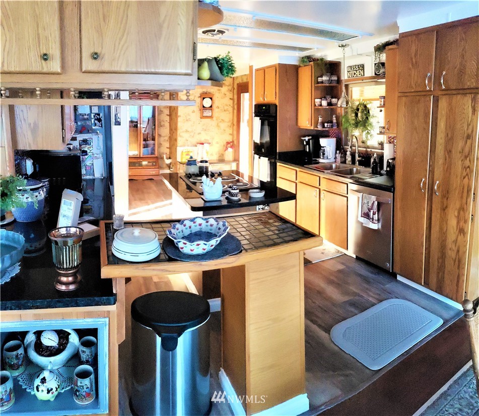 49 Sand Flat Road Omak, WA 98841 - Photo 12 of 40 a kitchen with stainless steel appliances granite countertop a refrigerator and a stove