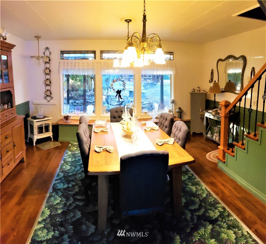 49 Sand Flat Road Omak, WA 98841 - Photo 16 of 40 a dining room with furniture a chandelier and wooden floor
