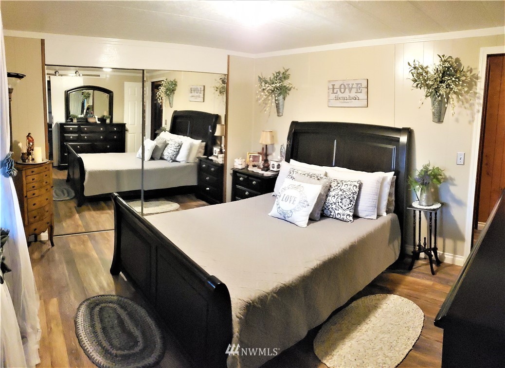 49 Sand Flat Road Omak, WA 98841 - Photo 20 of 40 a bedroom with a bed and wooden floor