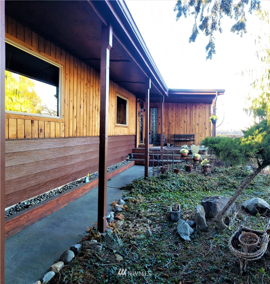 49 Sand Flat Road Omak, WA 98841 - Photo 3 of 40 a view of a backyard with plants and a patio