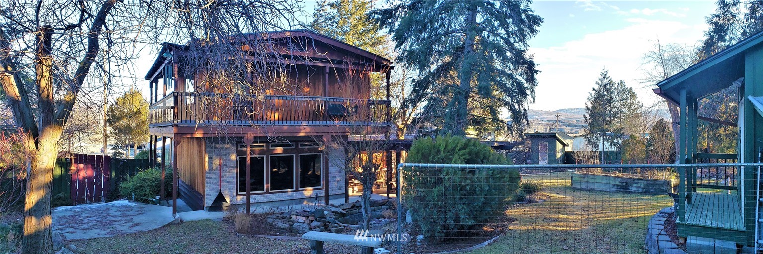 49 Sand Flat Road Omak, WA 98841 - Photo 33 of 40 a view of a house with large tree and wooden fence