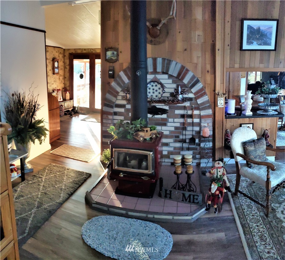 49 Sand Flat Road Omak, WA 98841 - Photo 7 of 40 a living room with fireplace furniture and a fireplace