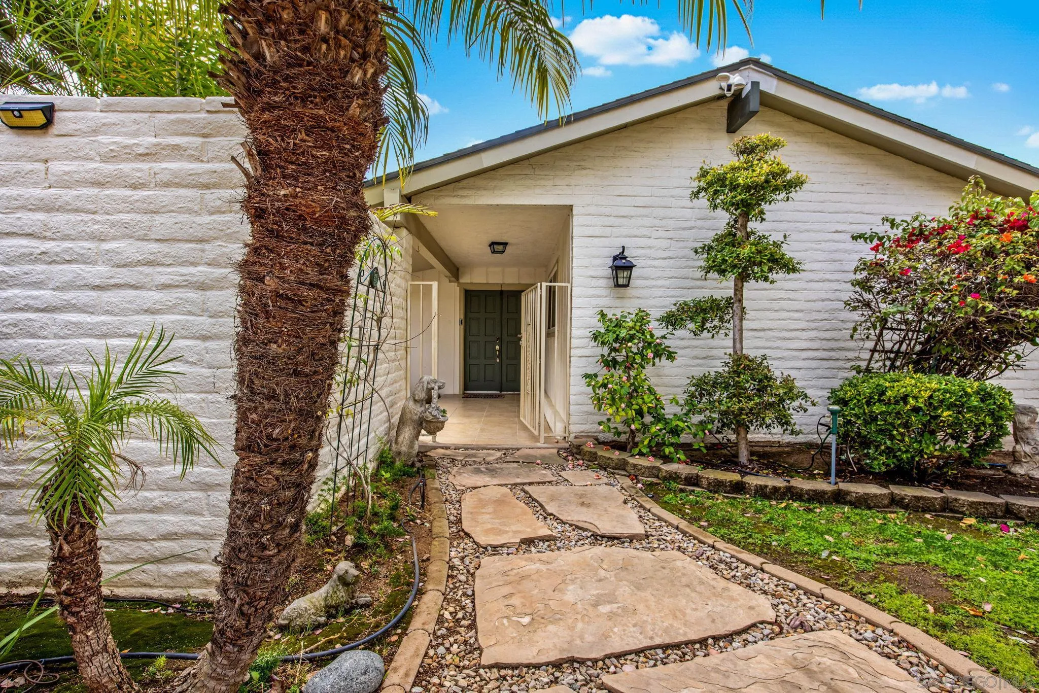 1673 Hidden Mesa Road El Cajon, CA 92019 - Photo 11 of 29 a view of a house with a small yard plants and floor to ceiling window