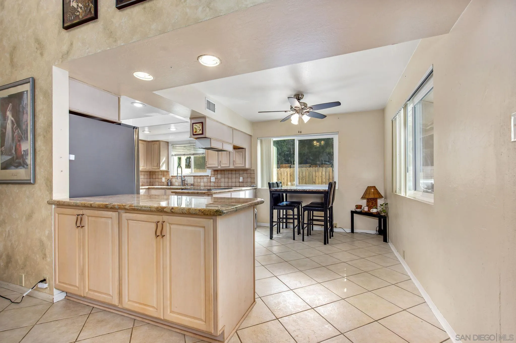 1673 Hidden Mesa Road El Cajon, CA 92019 - Photo 16 of 29 a kitchen with kitchen island granite countertop a sink cabinets and stainless steel appliances