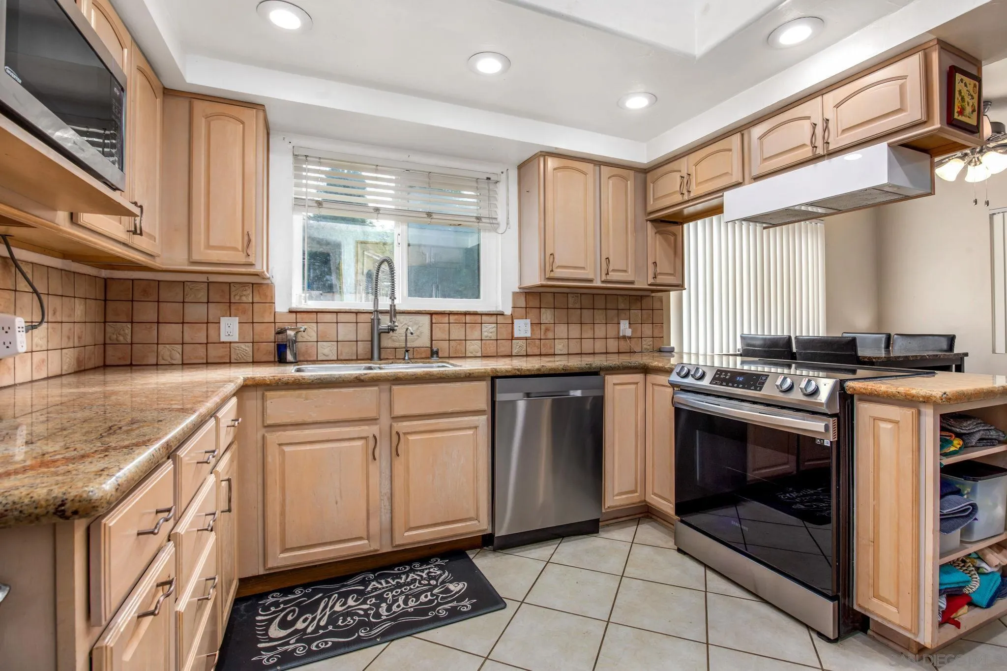1673 Hidden Mesa Road El Cajon, CA 92019 - Photo 20 of 29 a kitchen with stainless steel appliances granite countertop a stove a sink and a microwave